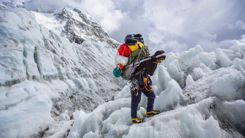 Sherpa descends the khumbu ice fall during the everest expedition